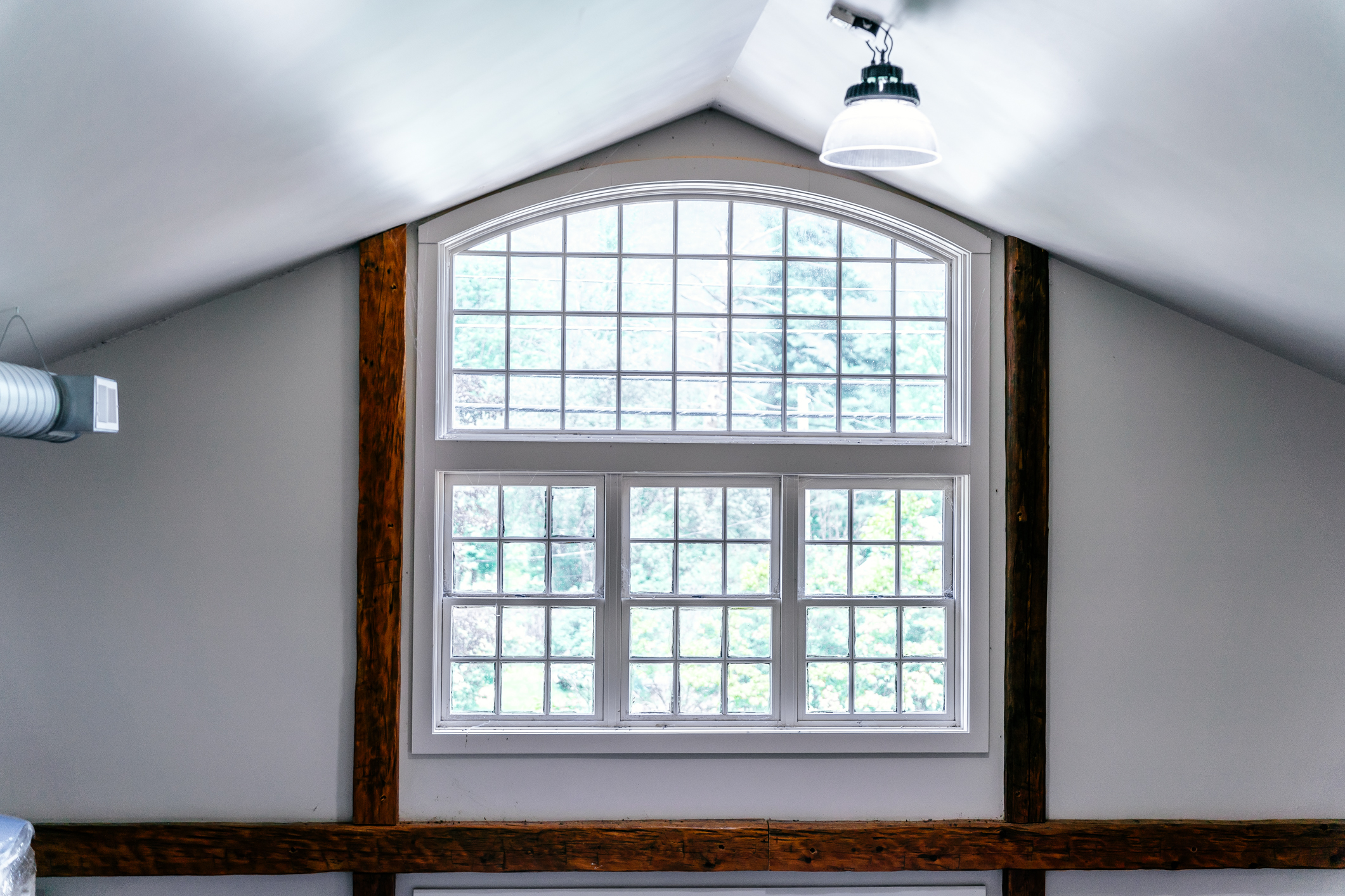 Architectural Arched Window with Hand-Hewn Beams